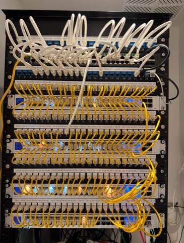 A modern network rack with organized patch cabling and switch equipment.